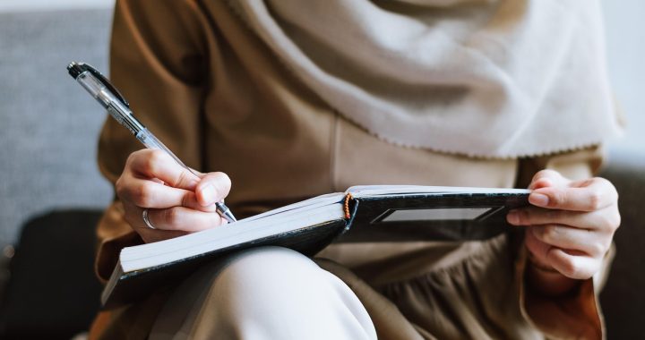 Muslim, woman, writing — Essential Construction Project Management Tools Every Contractor Needs